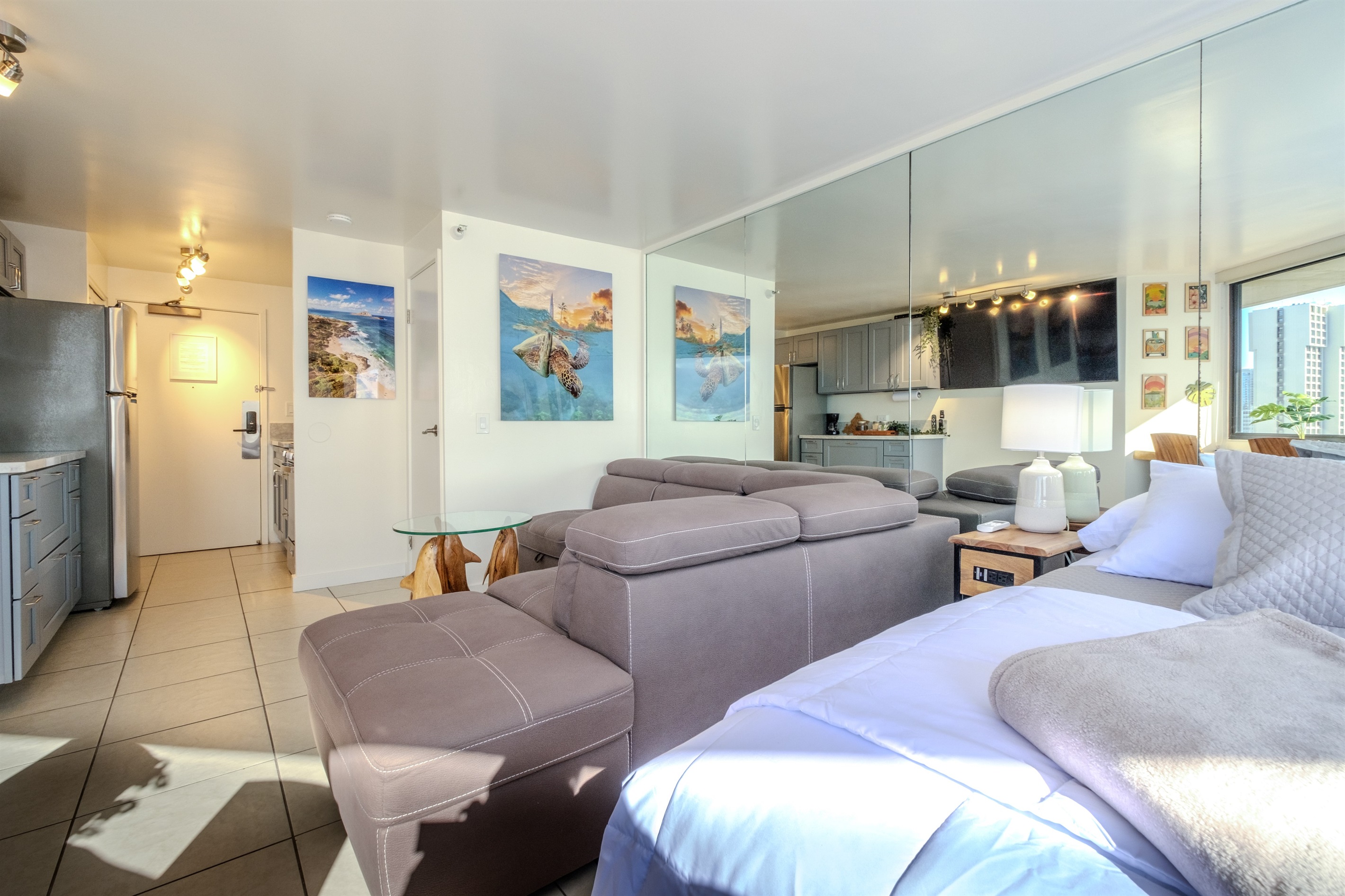 Discover your perfect island escape in this bright and modern Waikīkī studio. Designed for comfort and style, the open layout features plush seating, coastal artwork, and serene tones that reflect the spirit of Hawai‘i. Relax, recharge, and enjoy paradise