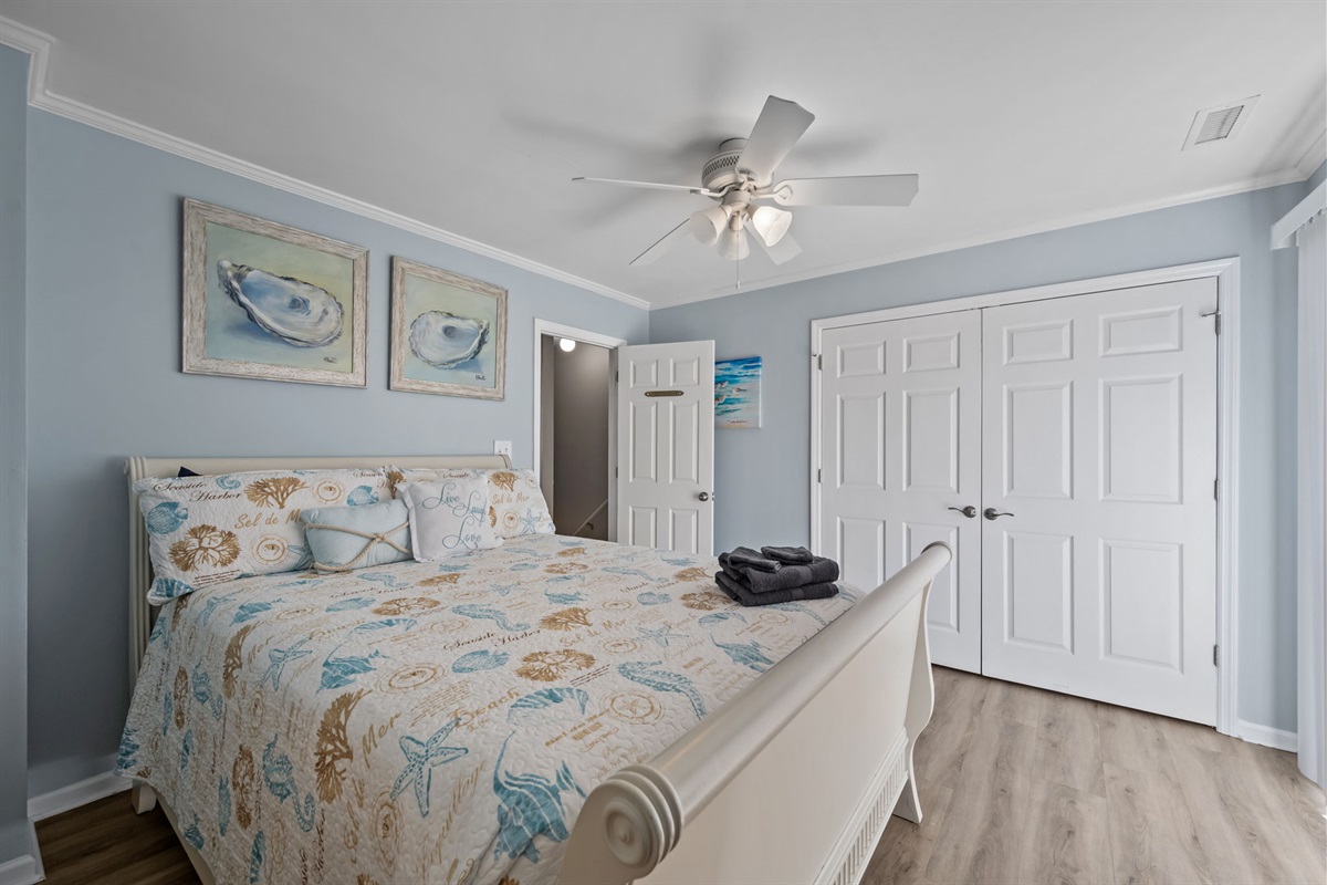 Master bedroom with large closet and coastal decor