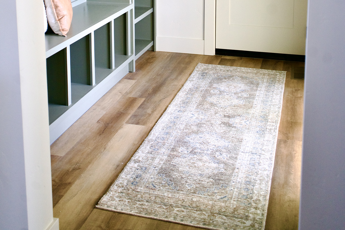 Upon entry, the home offers a thoughtfully designed space featuring a convenient seating area for removing shoes, hanging coats, and storing personal items such as purses. The layout provides both comfort and functionality.