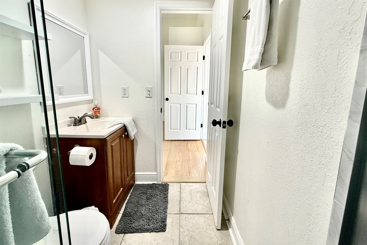 Whether you're getting ready for a day of adventure or winding down at night, this space offers everything you need — including a full-size glass shower, and essential toiletries.