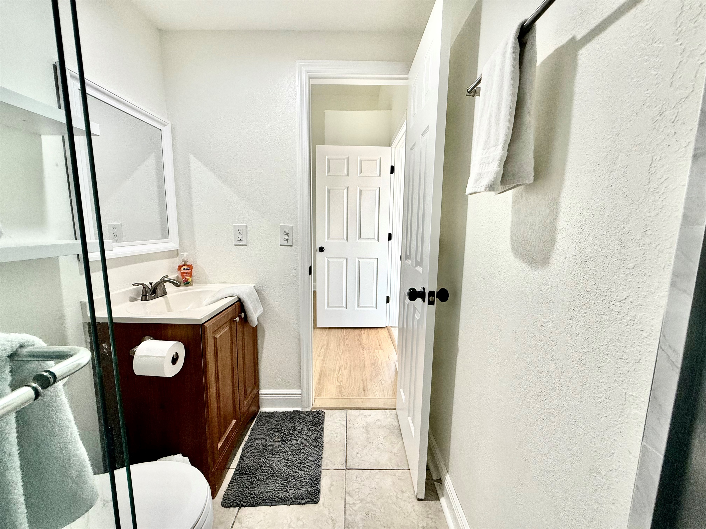 Whether you're getting ready for a day of adventure or winding down at night, this space offers everything you need — including a full-size glass shower, and essential toiletries.