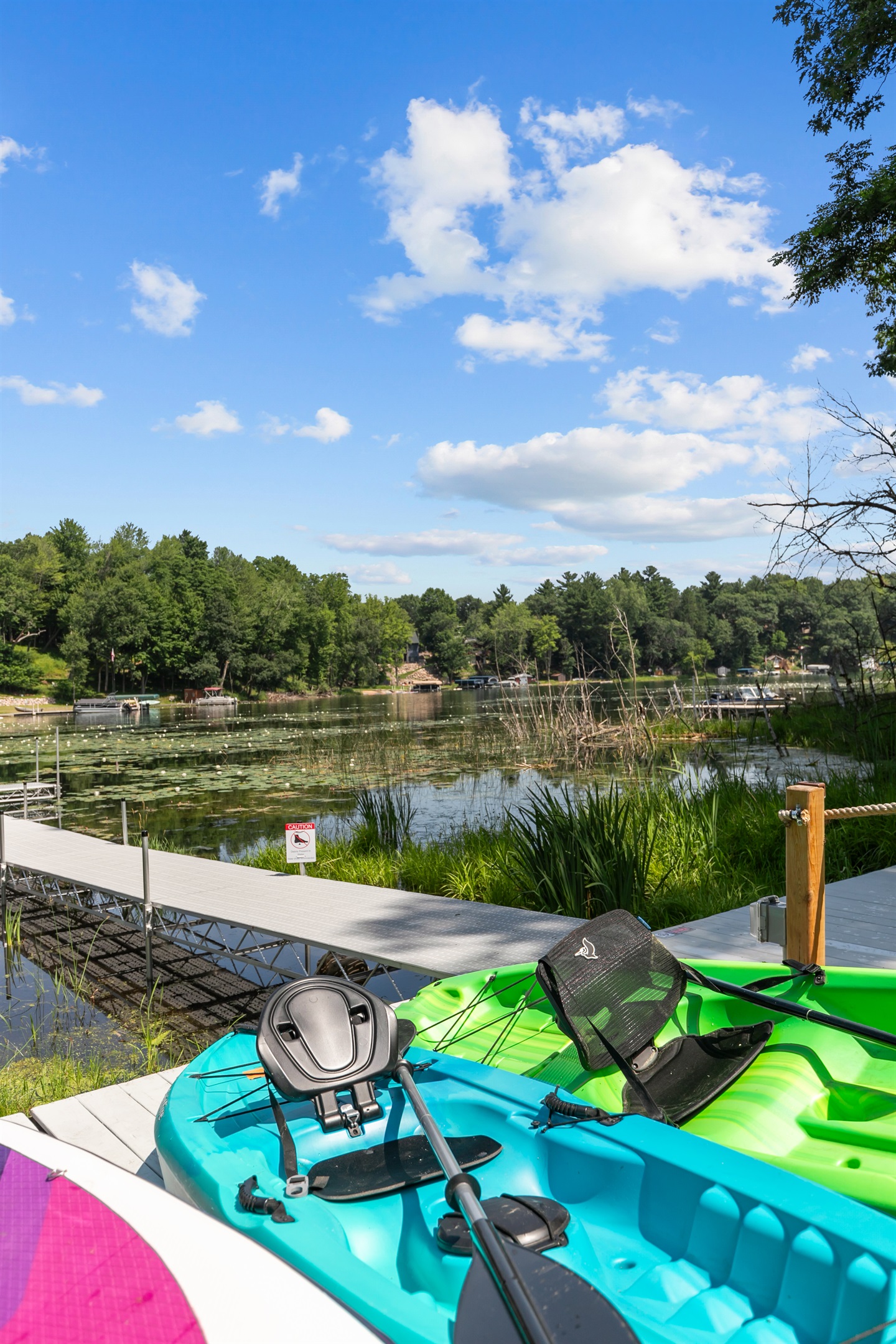 Kayaks and paddleboards are ready and waiting by the water—just grab one and glide across the lake!