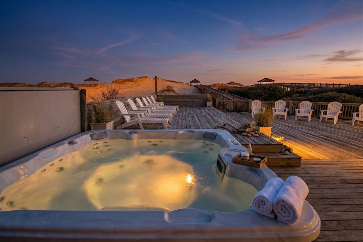 Relax in the large hot tub or soak up the sun on the expansive wooden deck, featuring Adirondack seating and direct access to the private beach walkway.