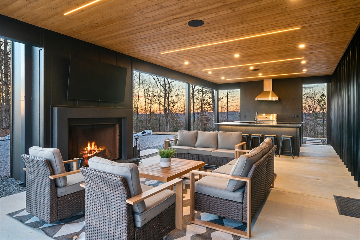 This covered patio feels like an outdoor living room, with comfy seating and a warm glow that makes it perfect for late-night chats and relaxing evenings.