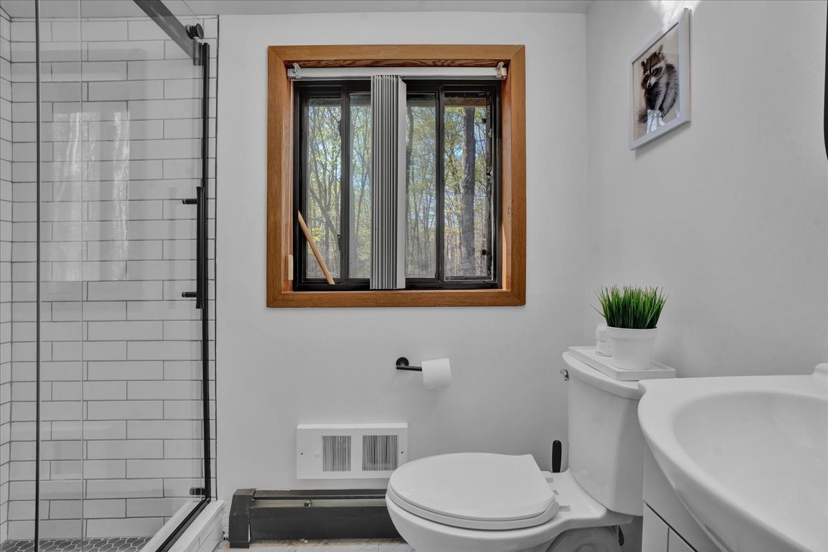 “Loft bathroom with fresh white tile and spa-inspired simplicity.”