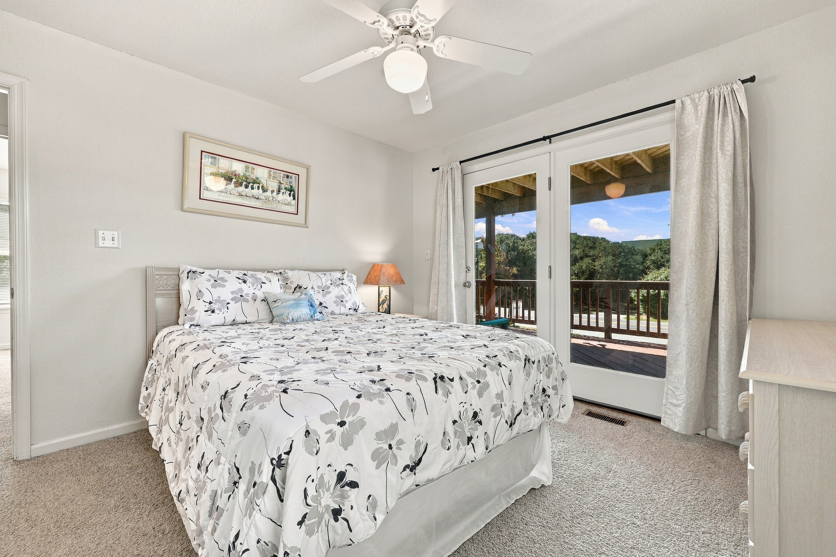 Fresh, breezy and bright, with French doors opening to the covered deck.