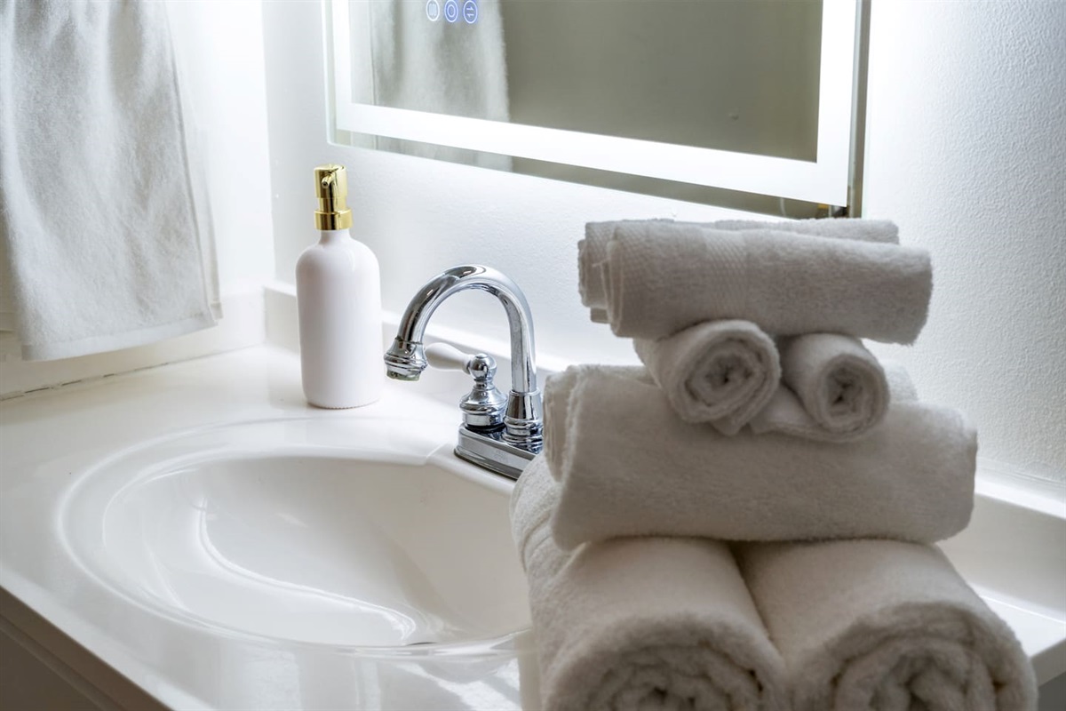 Crisp white towels, sleek finishes, and calming decor—our spa-inspired bathrooms are stocked and ready for your stay.