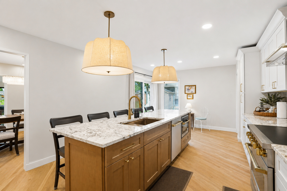 Modern kitchen with large island, quartz countertops, and warm pendant lighting. Open, bright layout perfect for cooking, dining, and entertaining.