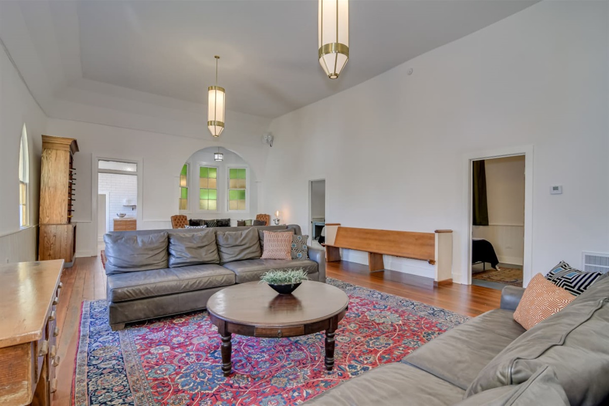 Bright lounge with colorful vintage rug and cozy seating.