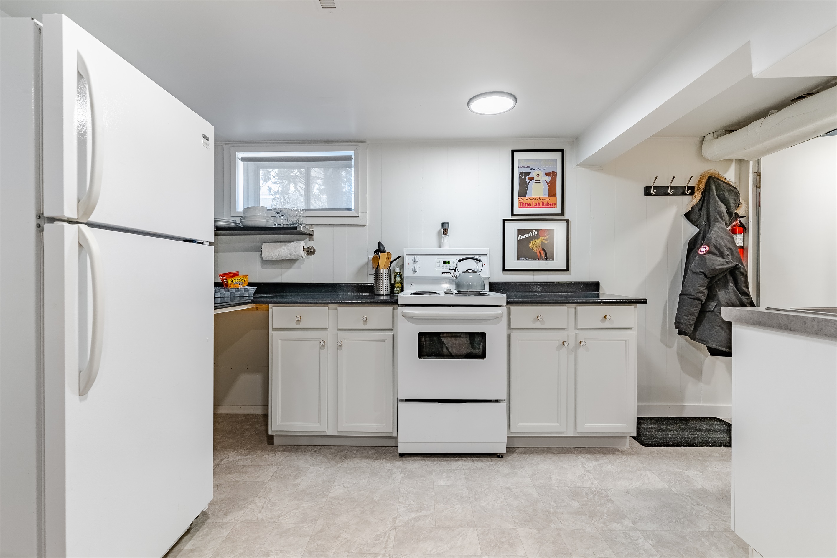 Basic cooking setup with stove, cookware, and dishware for simple meals.