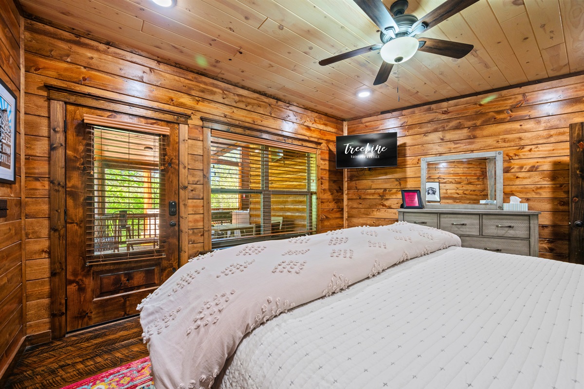 A bright and airy bedroom offers large windows and a relaxing space to recharge after a day of exploring.
