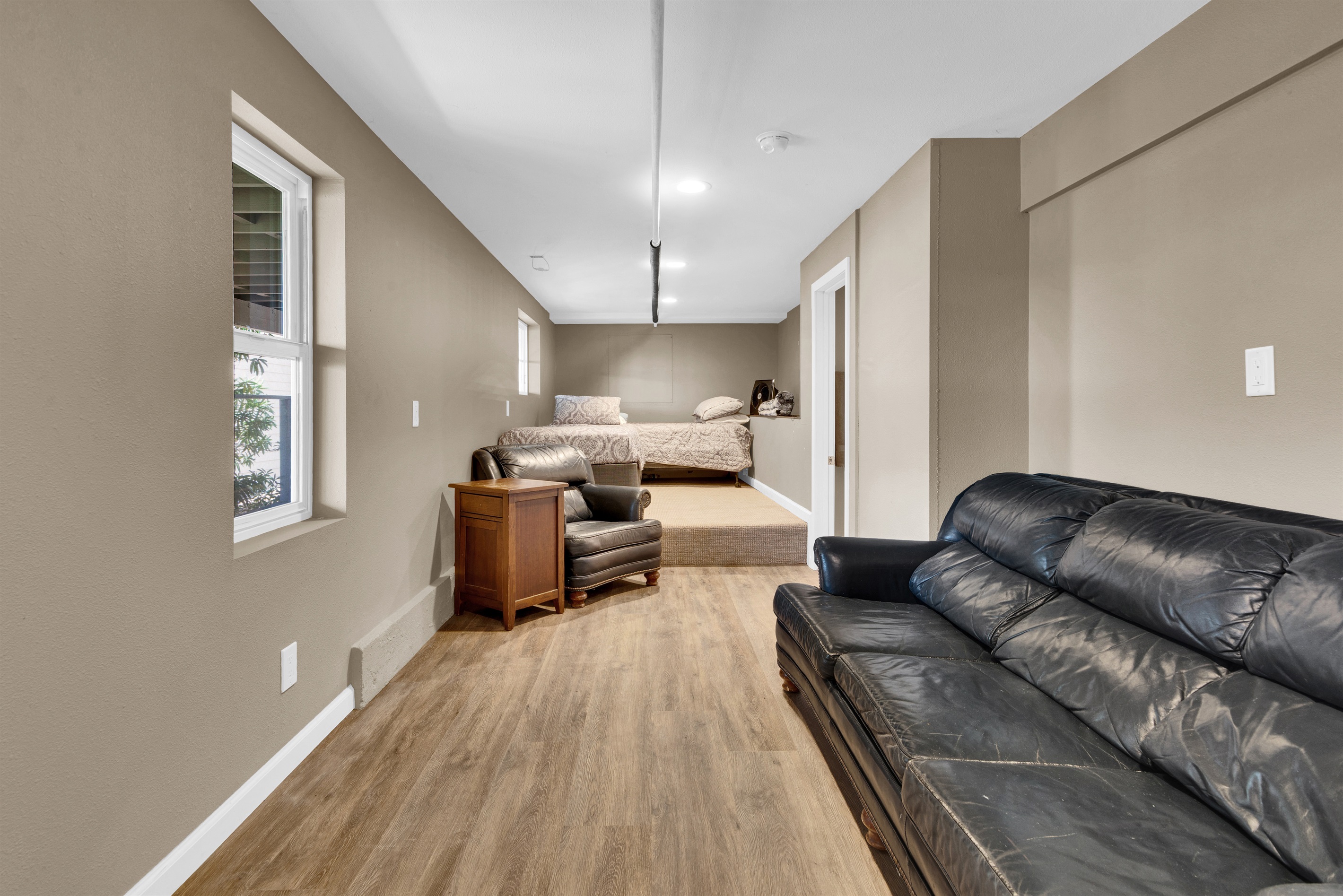 Lower bunk room with a bathroom, sofa and two extra twin beds.