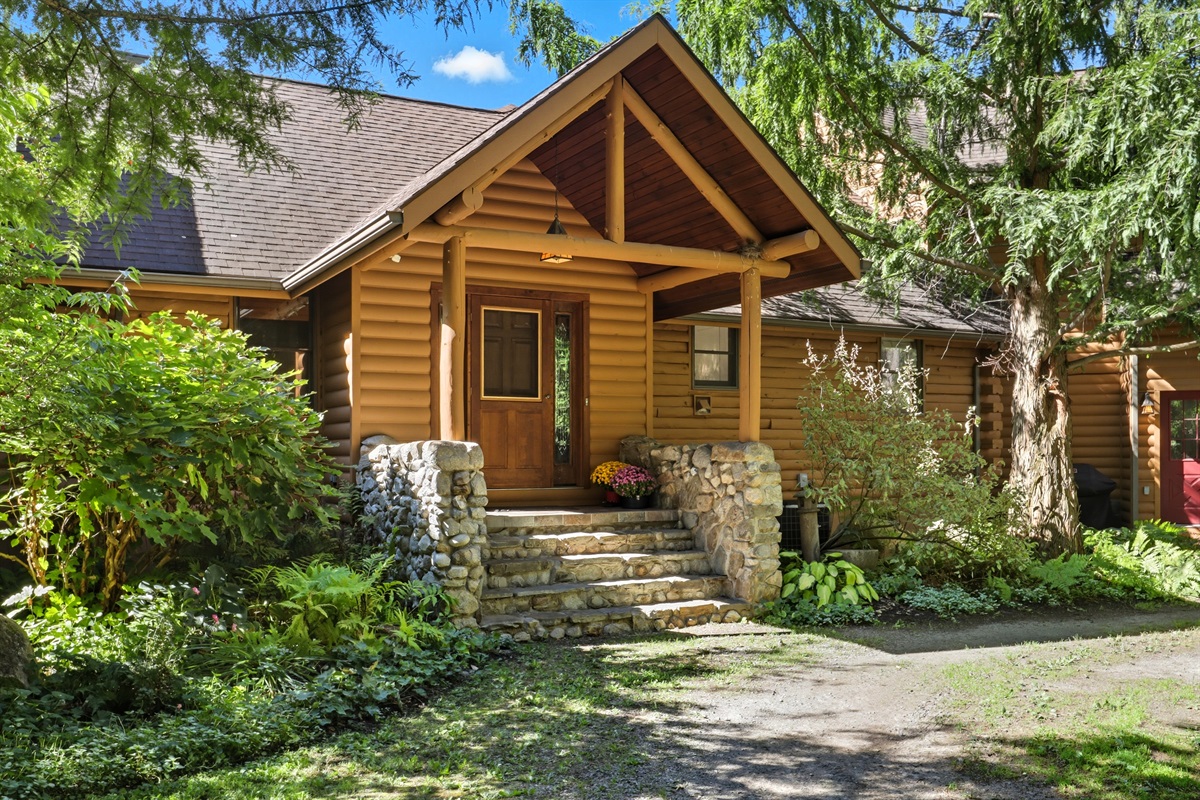 Inviting stone steps and a timber-framed porch welcome you into this warm and rustic retreat.