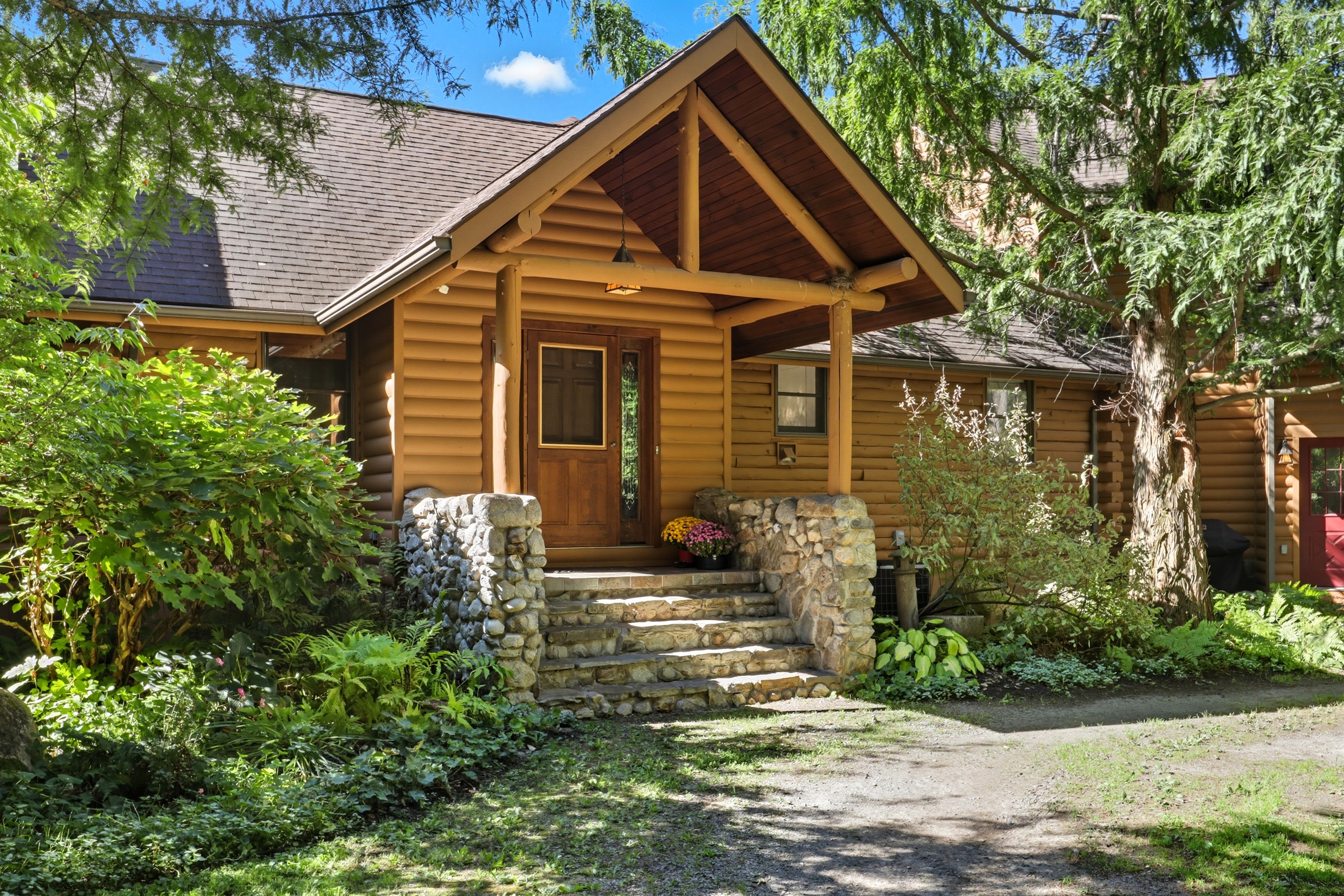 Inviting stone steps and a timber-framed porch welcome you into this warm and rustic retreat.