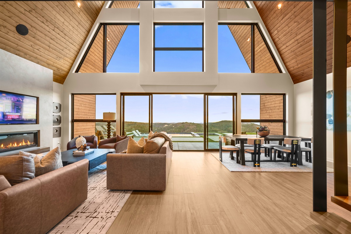 Walking into this bright, open living space feels instantly welcoming, with tall windows, warm wood details, and plenty of room for everyone to spread out comfortably.