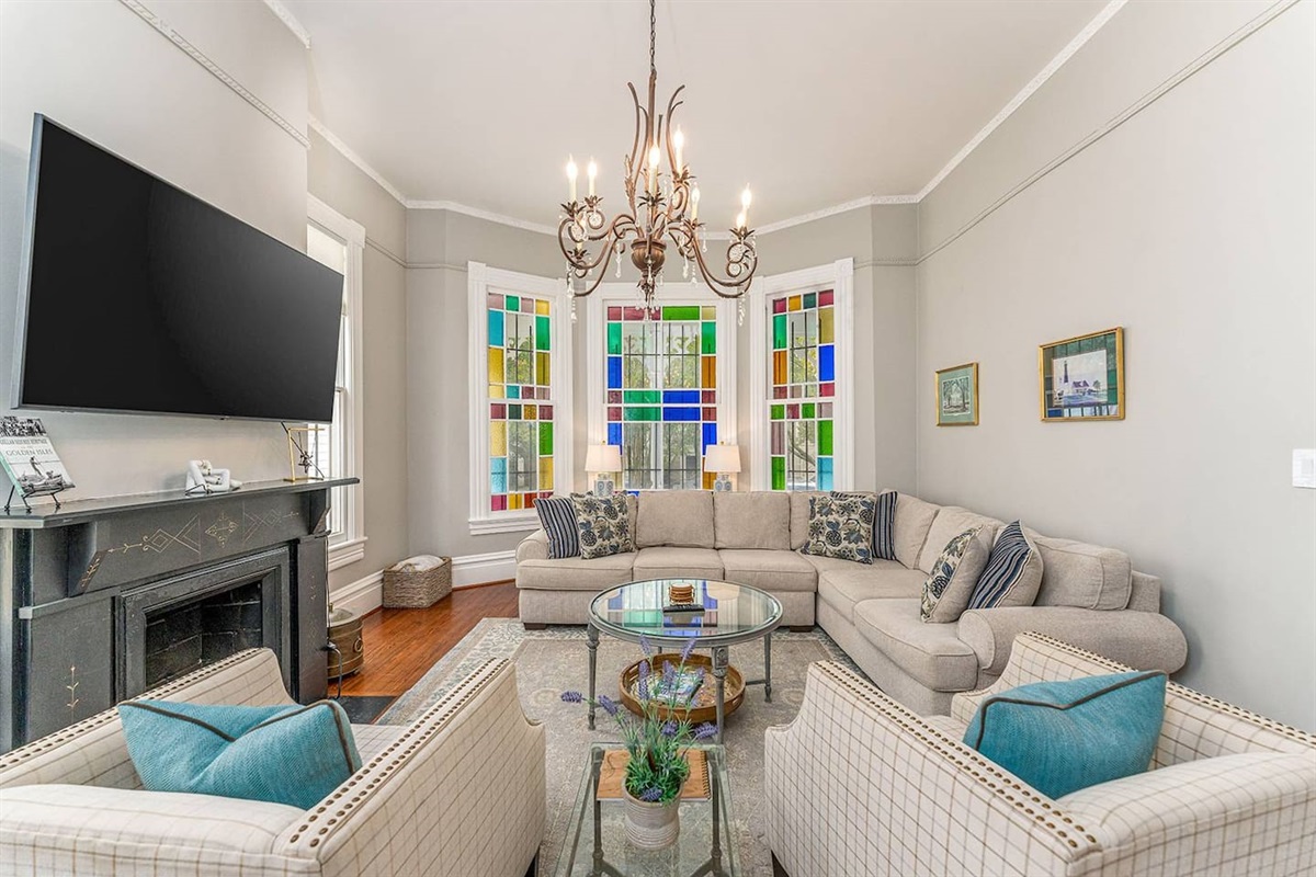 Stain glass windows facing south let in brilliant light throughout the day!  Spacious with double pocket doors leading into the dining room - great for entertaining.  Close the pocket doors, pull out the sofa bed make this living room a 4th bedroom!