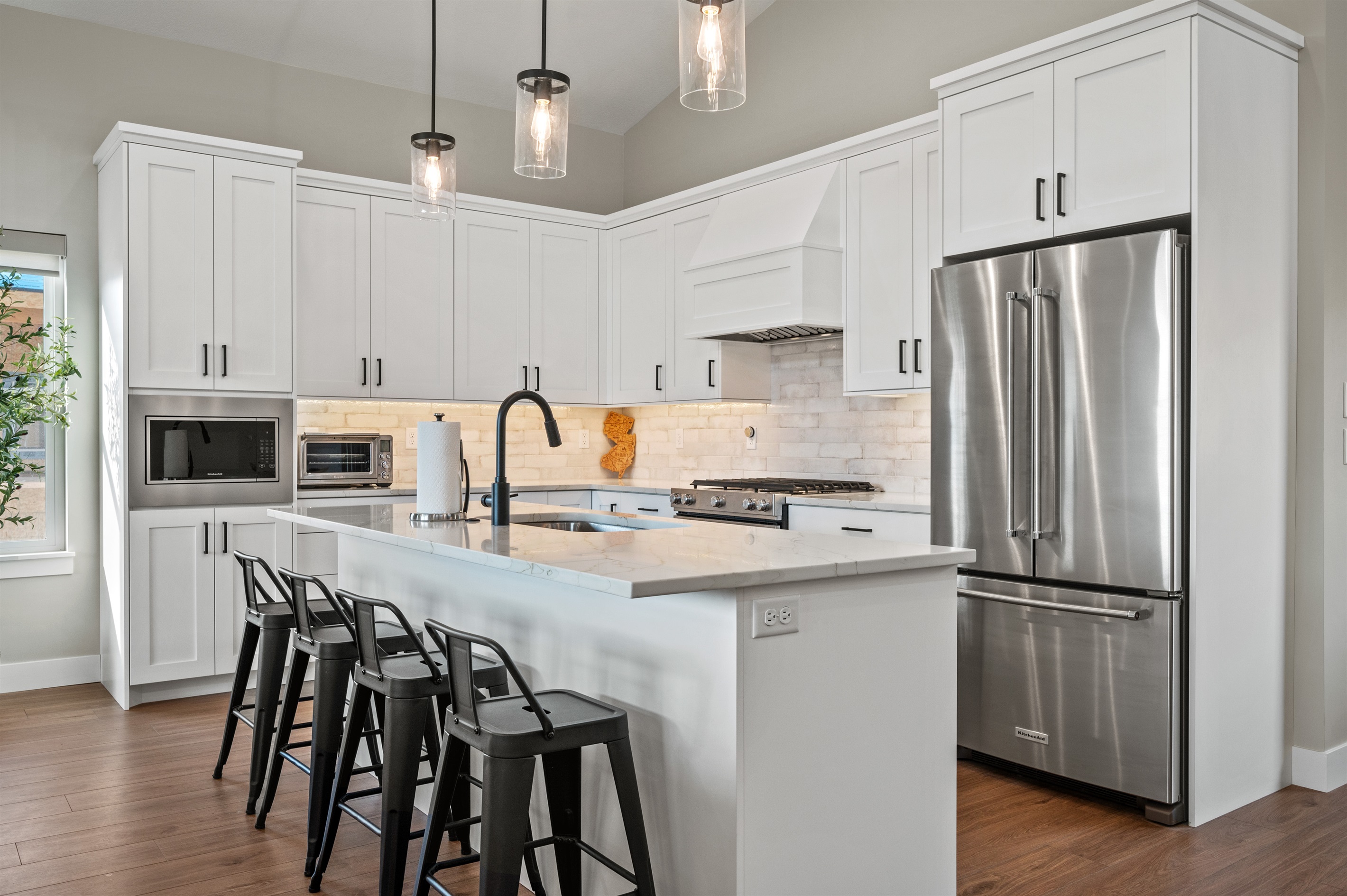 Gather at the island with sink and seating for four in the heart of the kitchen.