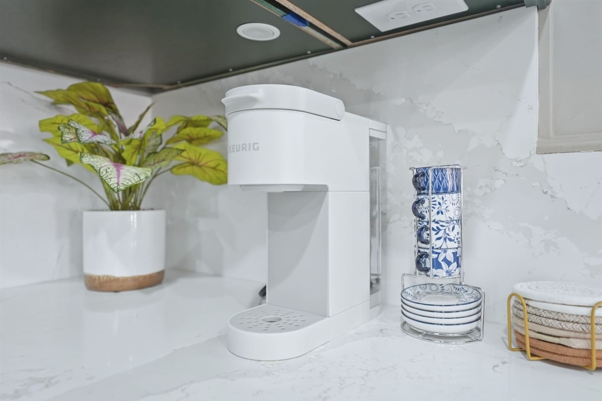 Coffee lovers will appreciate the Keurig setup with mugs and pods ready for a fresh cup whenever you need it.