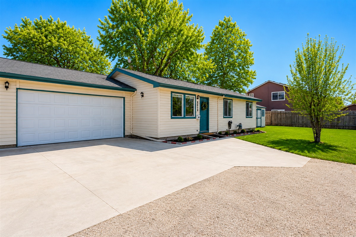 Apt. 1: Exterior view including yard and 2-car garage.