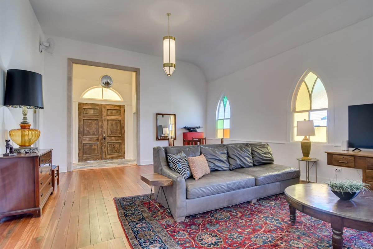 Formal living room with patterned rug and stylish accents.