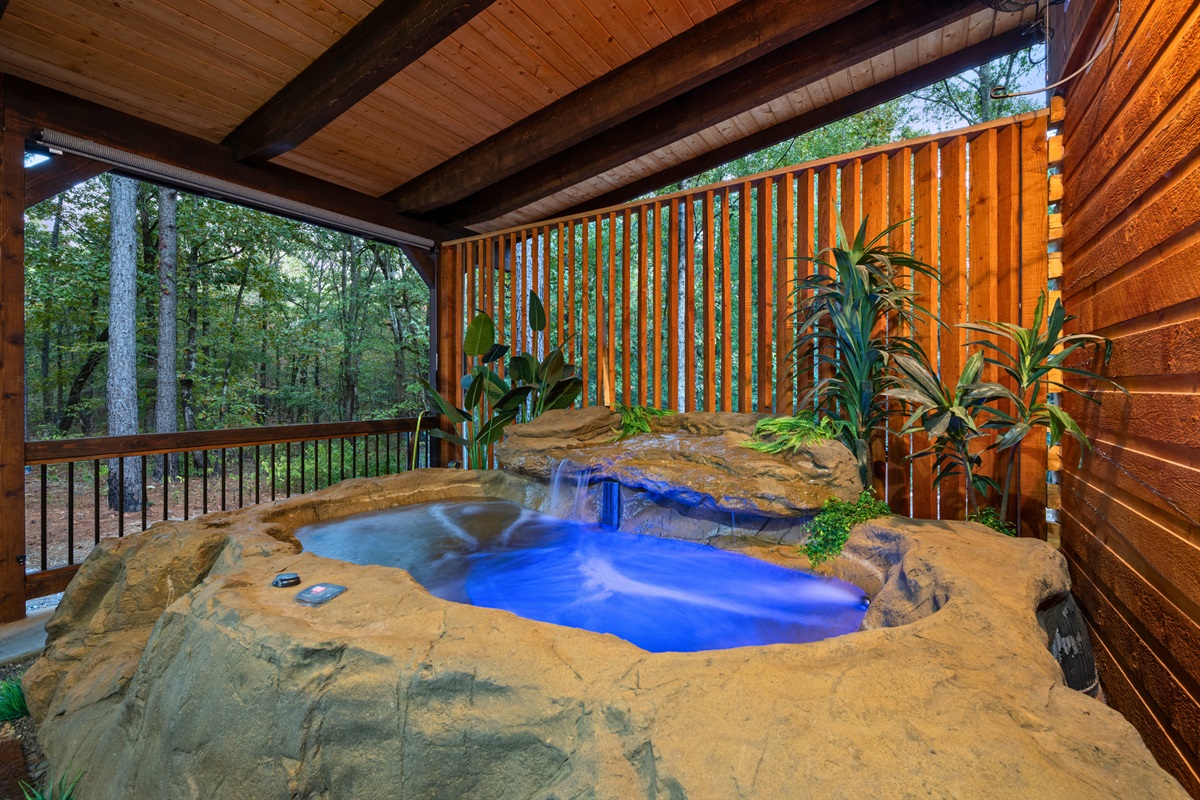 Private spa-style hot tub surrounded by natural wood accents.