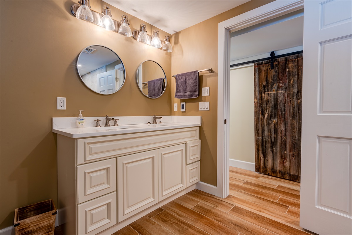 Bottom Floor bathroom with dual shower heads including a rain head and a large soaking tub!