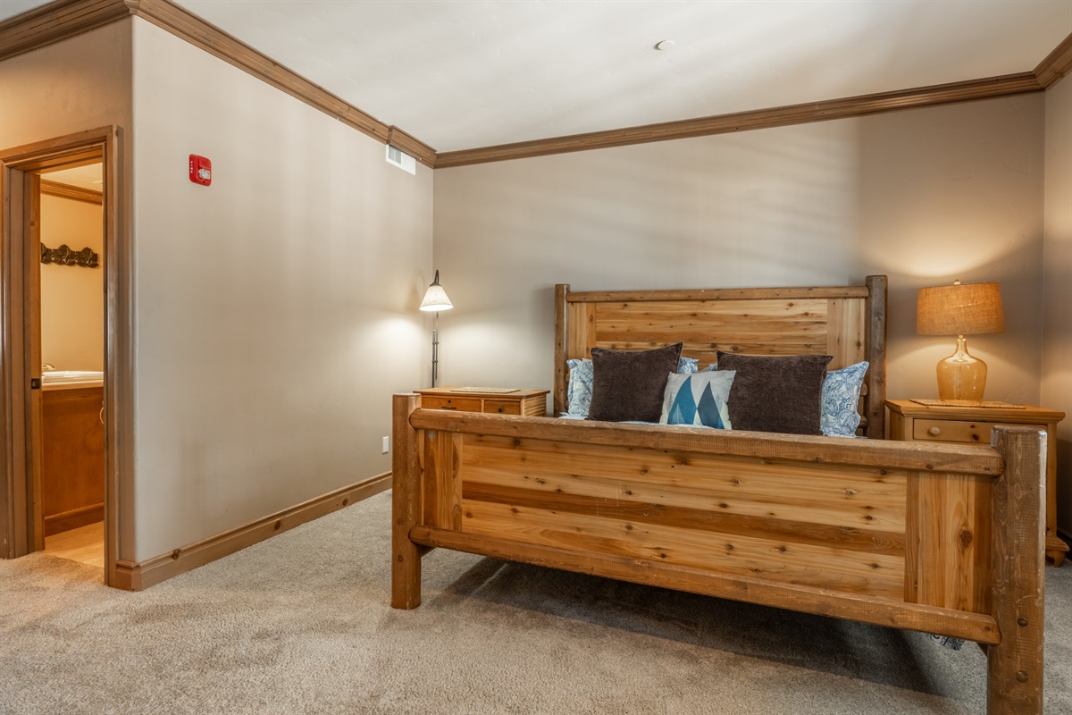 The primary bedroom is tucked off its own hallway with an en-suite bath—creating a private, peaceful retreat within the home.