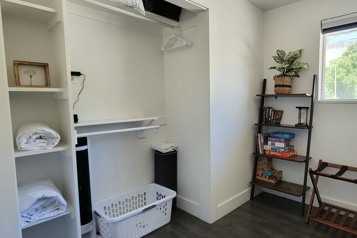 Closet in third bedroom. Pack n' play, extra blankets, pillows, and sheets. Bookshelf with toys, books, and games.