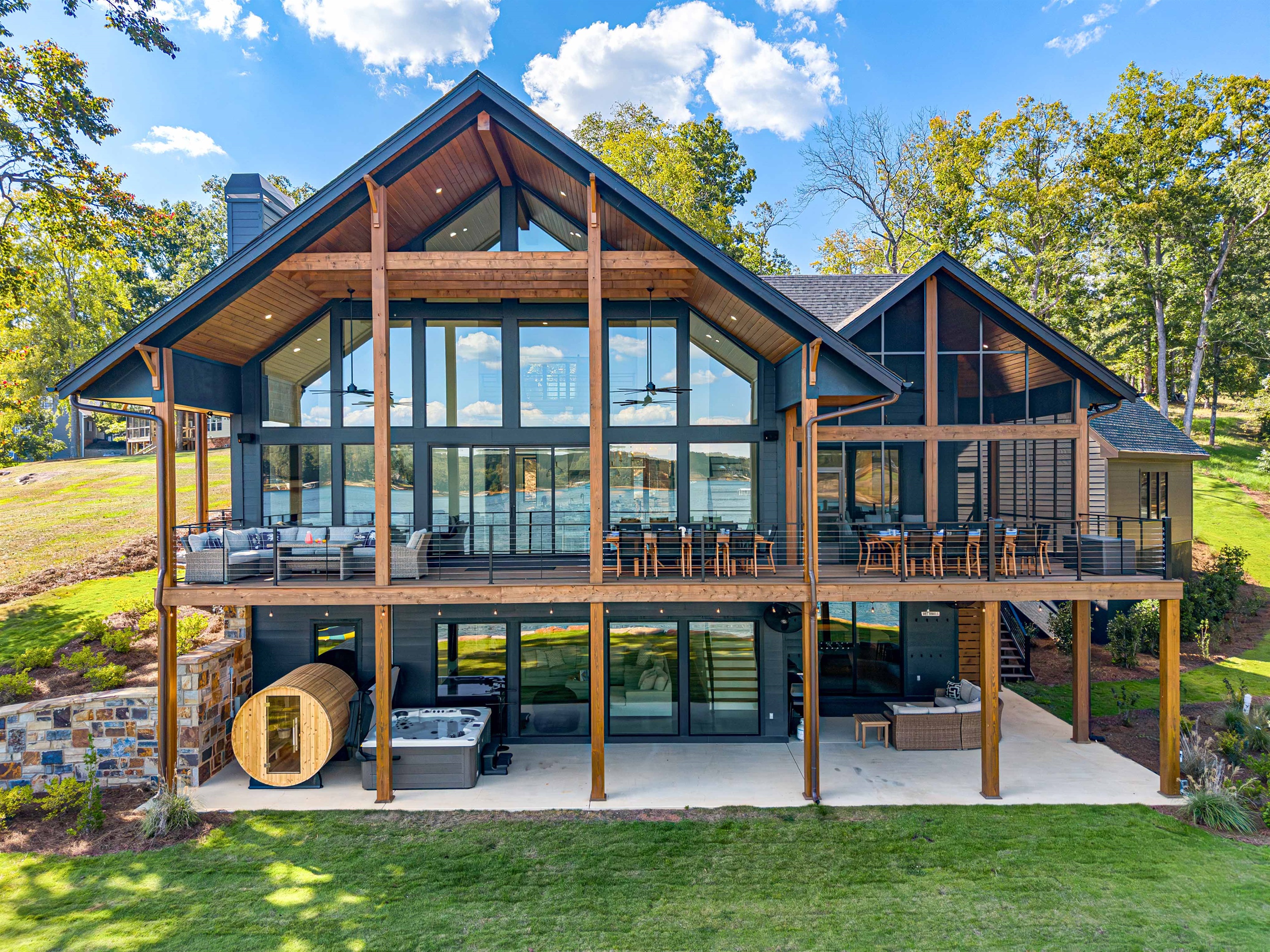 Rear elevation with outdoor dinning, seating, sauna and hot tub.