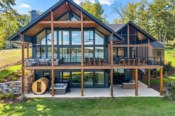 Rear elevation with outdoor dinning, seating, sauna and hot tub.