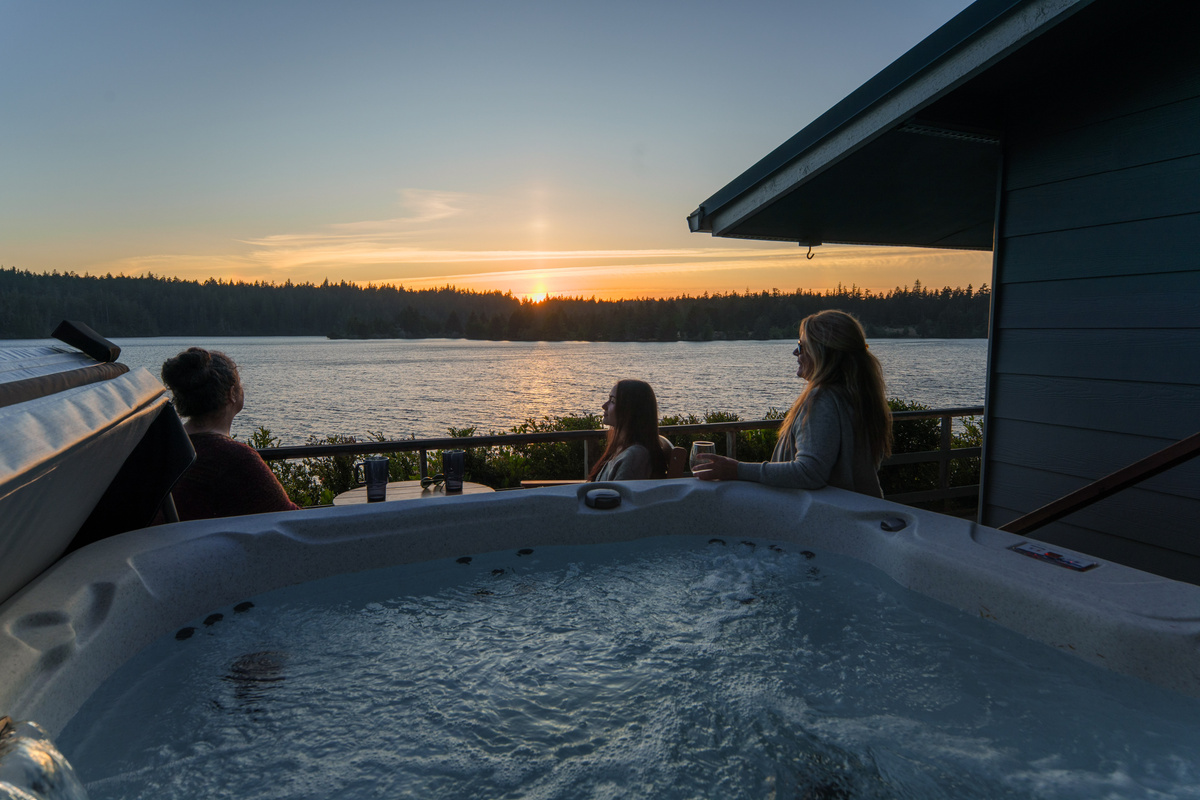 Soak in the hot tub as the sun sets over Woahink Lake—the perfect way to unwind, reconnect, and end the day surrounded by peaceful waterfront views.