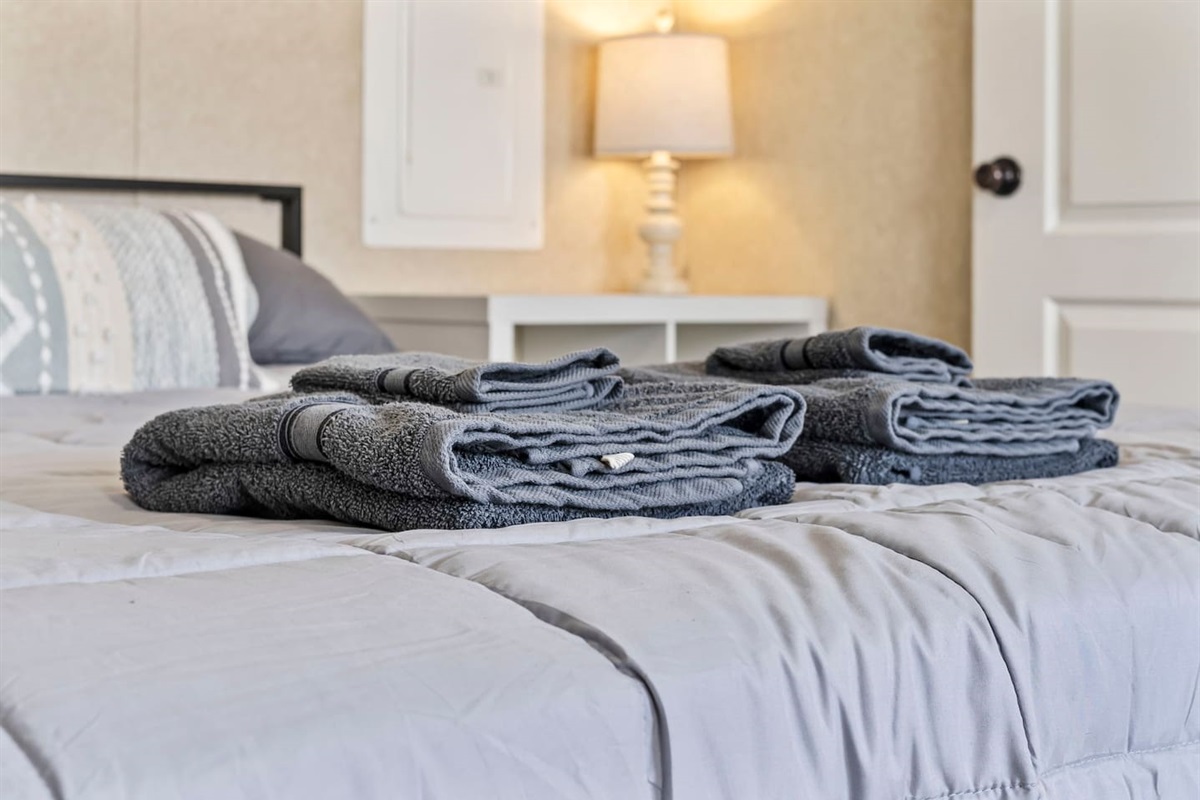 Fresh towels neatly prepared on the bed—ready for your comfortable and convenient stay.