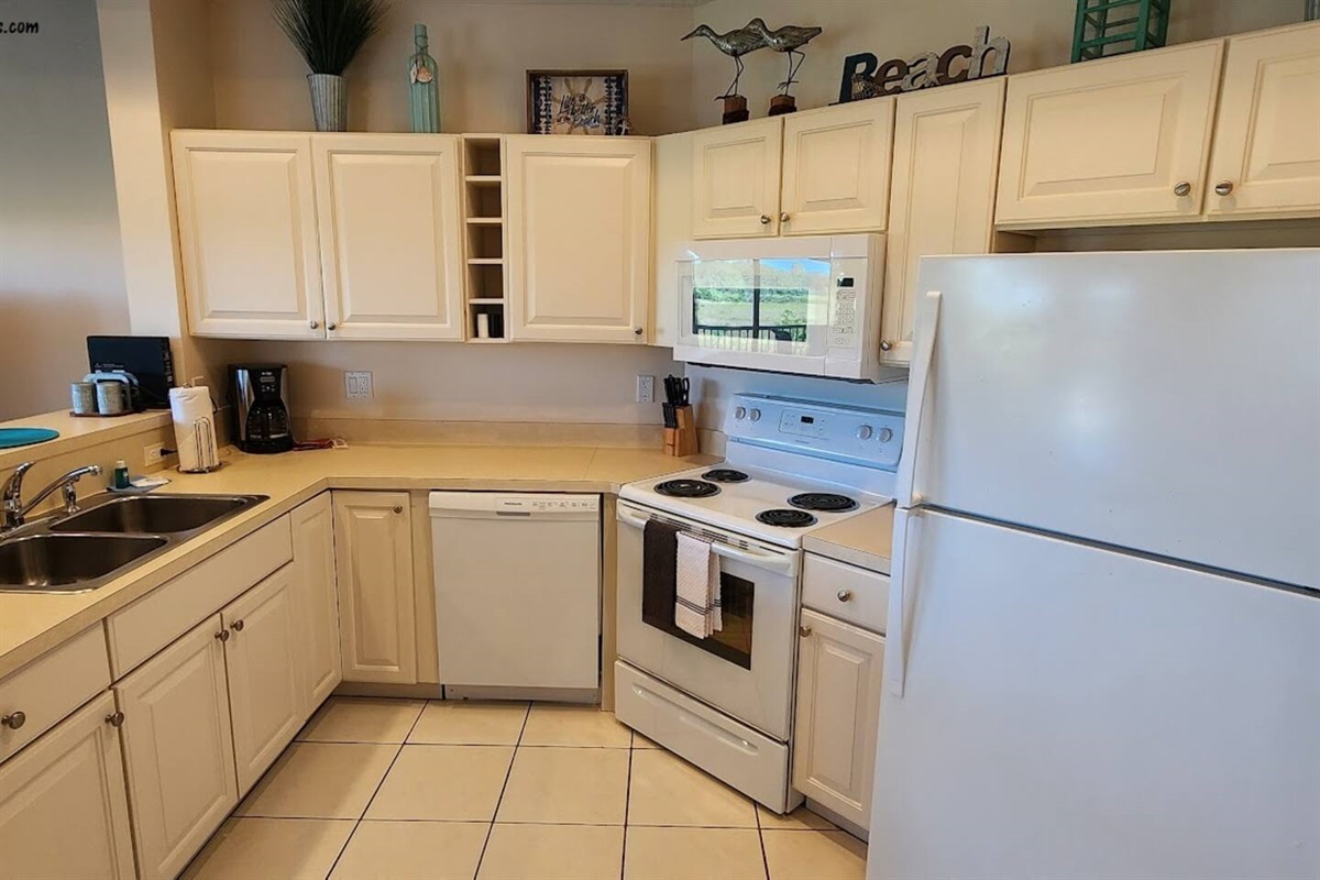 Fully equipped kitchen with plenty of cabinet space, full-size appliances, and a bright, functional layout.