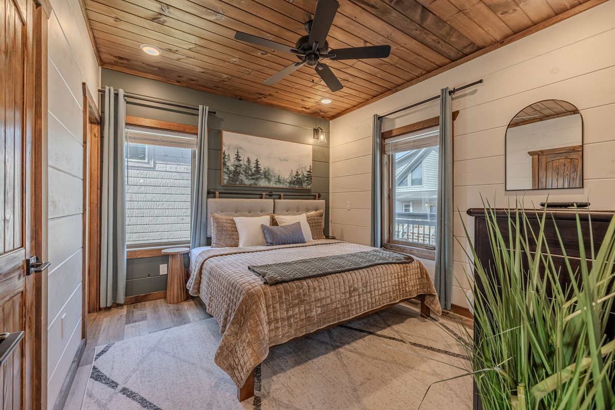 Main level king bedroom with bedside lighting and a comfortable setup.