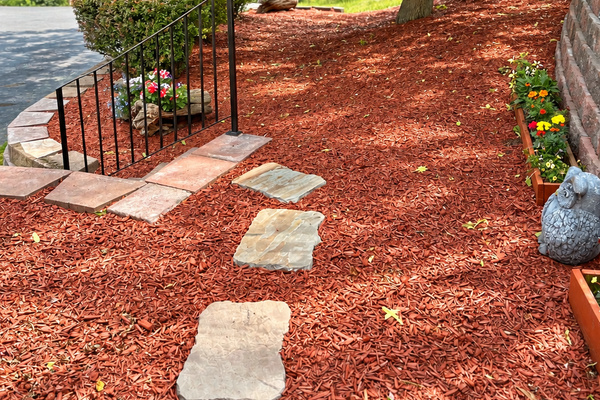 Terraced walkway from driveway to backyard with grill and pool