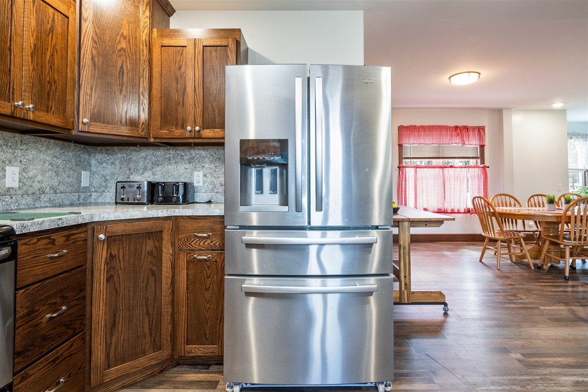 Sleek kitchen design with full-size fridge and plenty of storage for long stays.