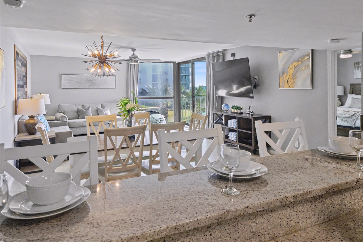 Counter seats, dining area, and living room with beach views