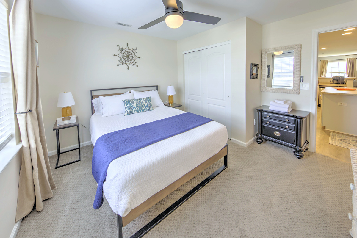 Fresh linens provided and beds professionally made before arrival—no linen rentals required.

Bedroom 3: Tranquil retreat with modern decor, a comfy queen bed, sunny coastal vibes, and blackout curtains.