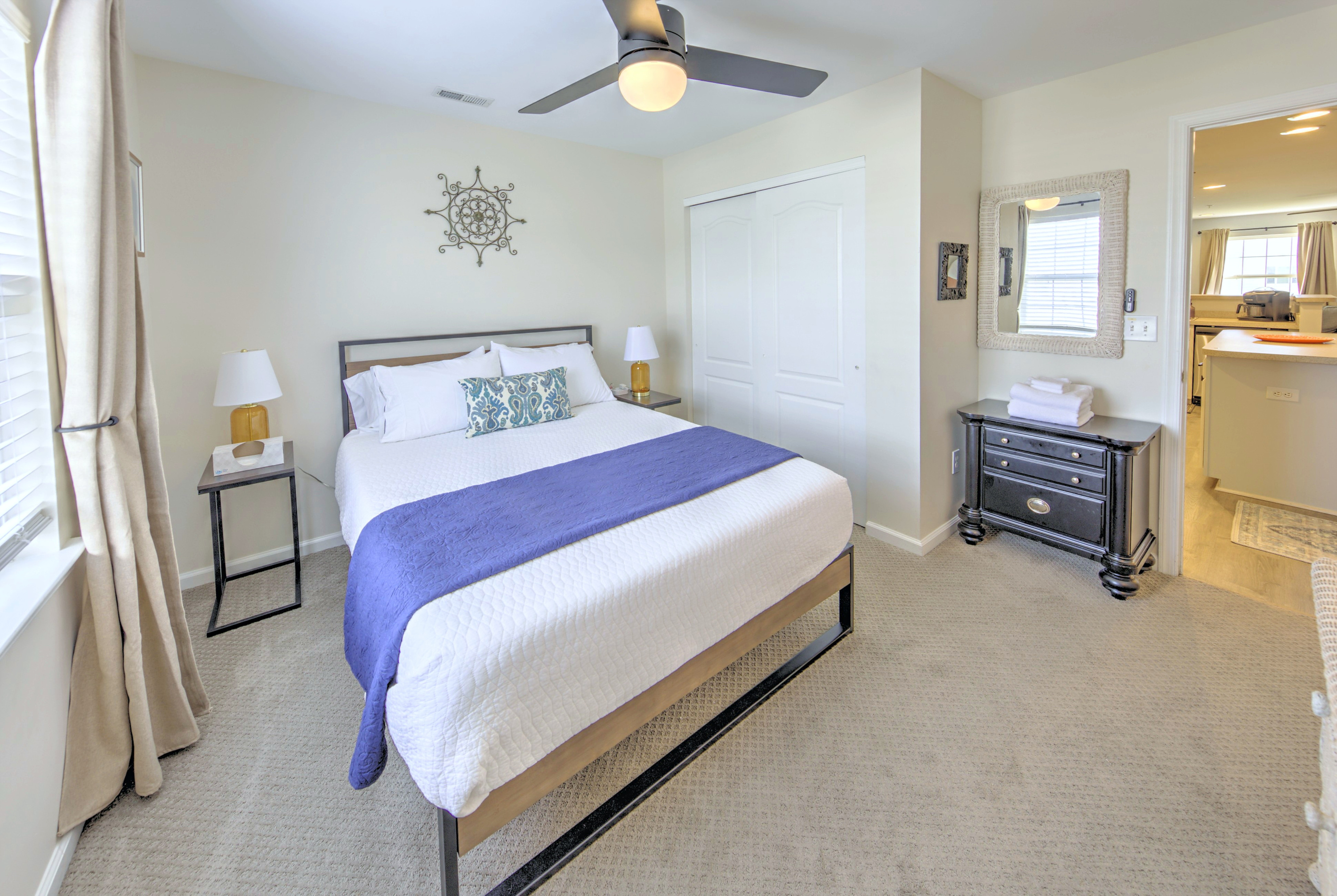 Fresh linens provided and beds professionally made before arrival—no linen rentals required.

Bedroom 3: Tranquil retreat with modern decor, a comfy queen bed, sunny coastal vibes, and blackout curtains.
