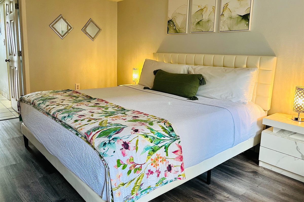 Relax in a spacious and elegantly decorated bedroom with plush bedding and soothing coastal tones.