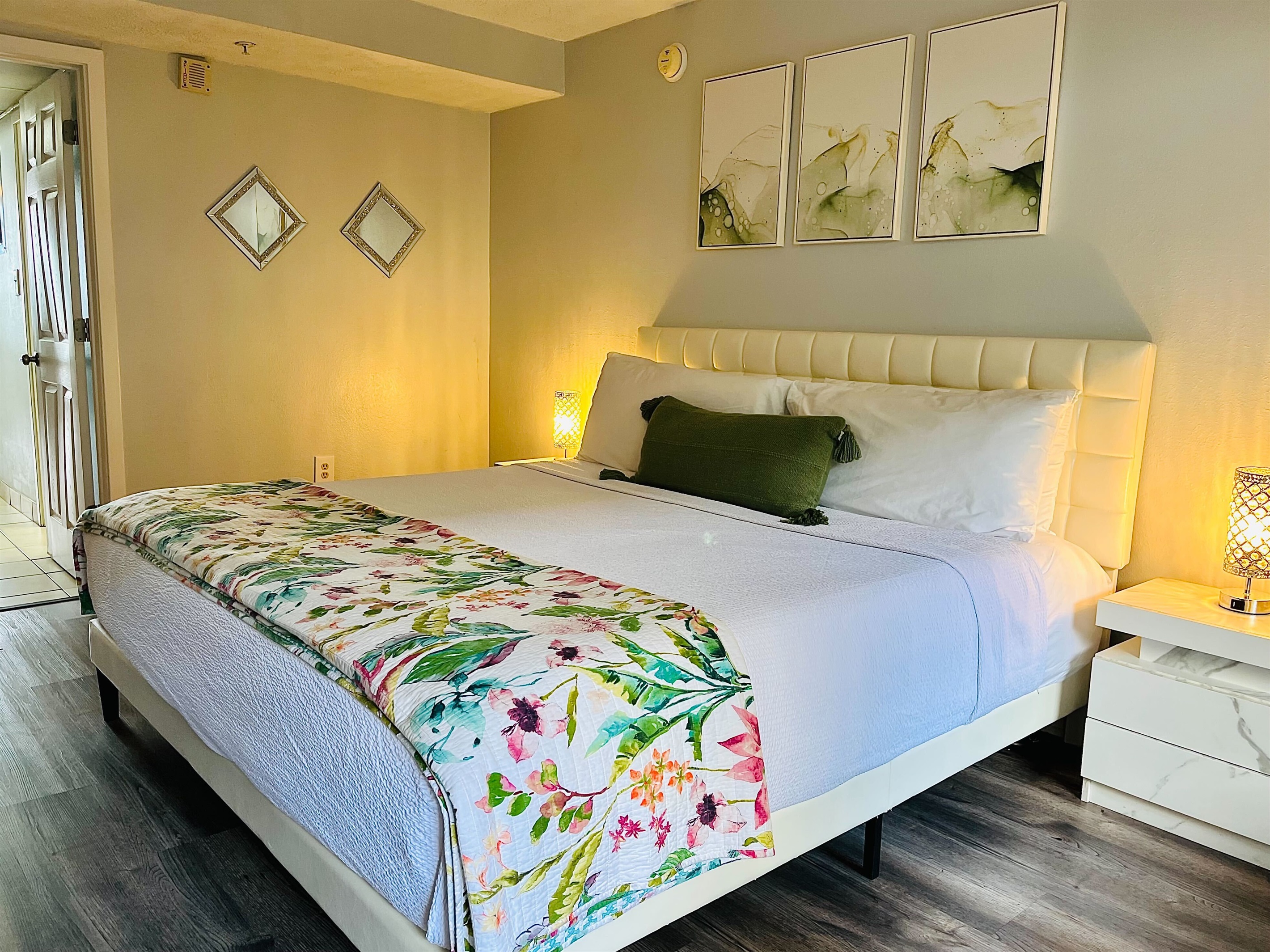 Relax in a spacious and elegantly decorated bedroom with plush bedding and soothing coastal tones.