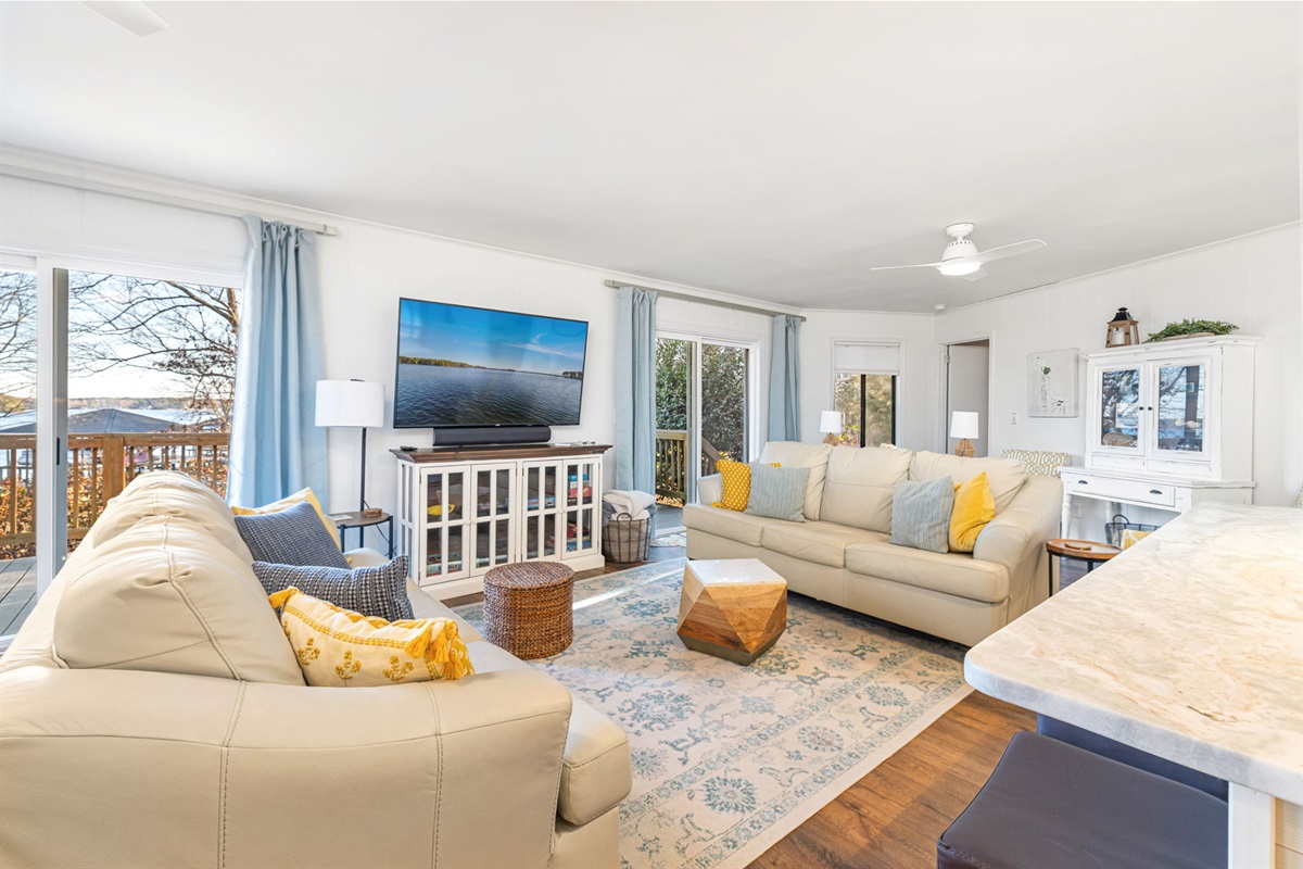 Living Room Oasis: Sunlit space with beautiful views, comfy seating, and stylish decor awaits!