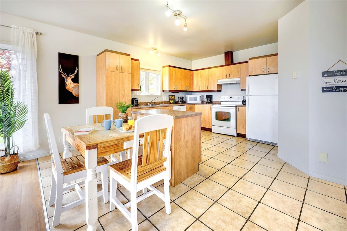 Compact kitchenette paired with a charming dining area.