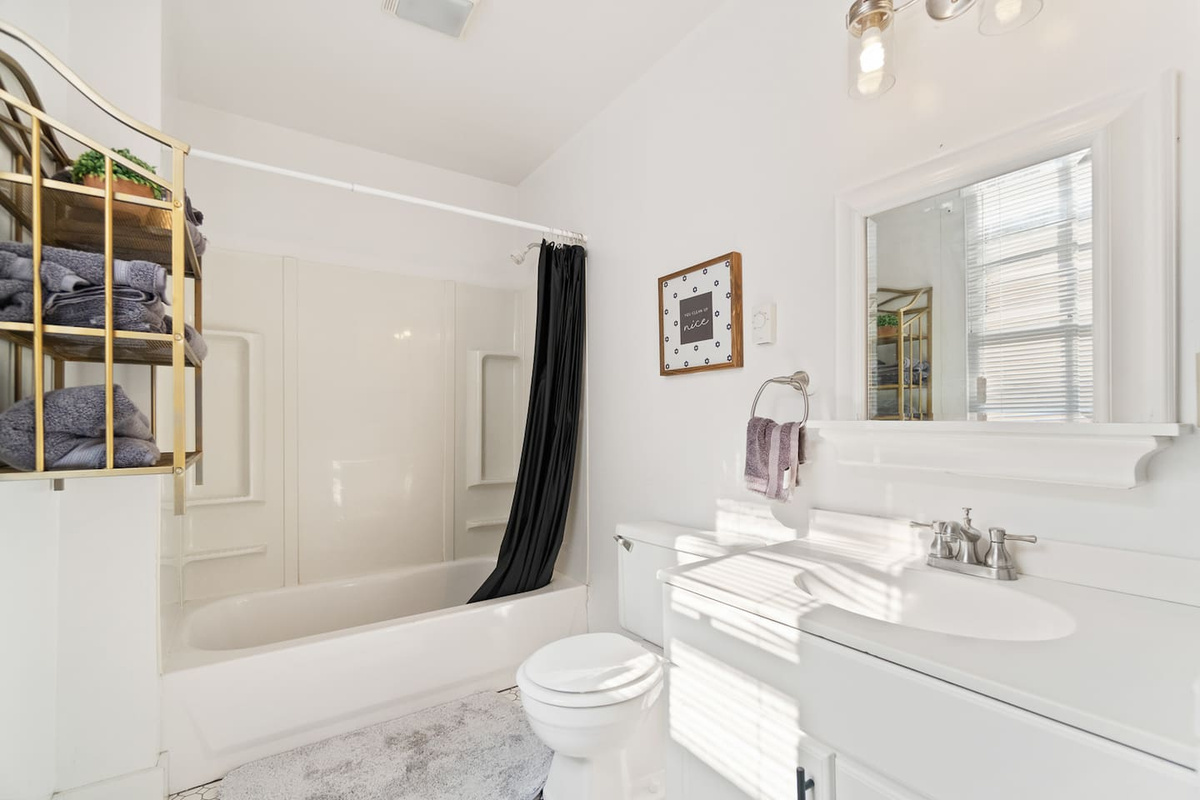 Spacious full bathroom featuring a relaxing bathtub, perfect for unwinding after a long day, along with sleek fixtures and modern finishes for a comfortable experience.