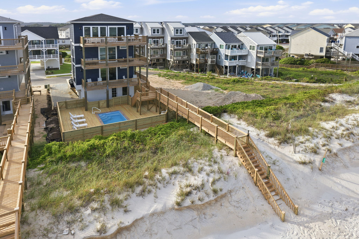 Aerial exterior overview of the property showing pool deck and beach boardwalk access