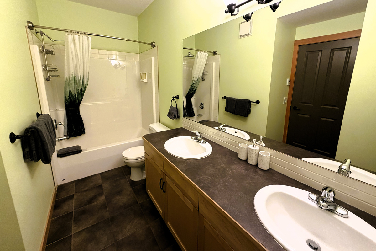 Master ensuite bathroom, with his and hers sink, shower, and tub.   Heated floor! 