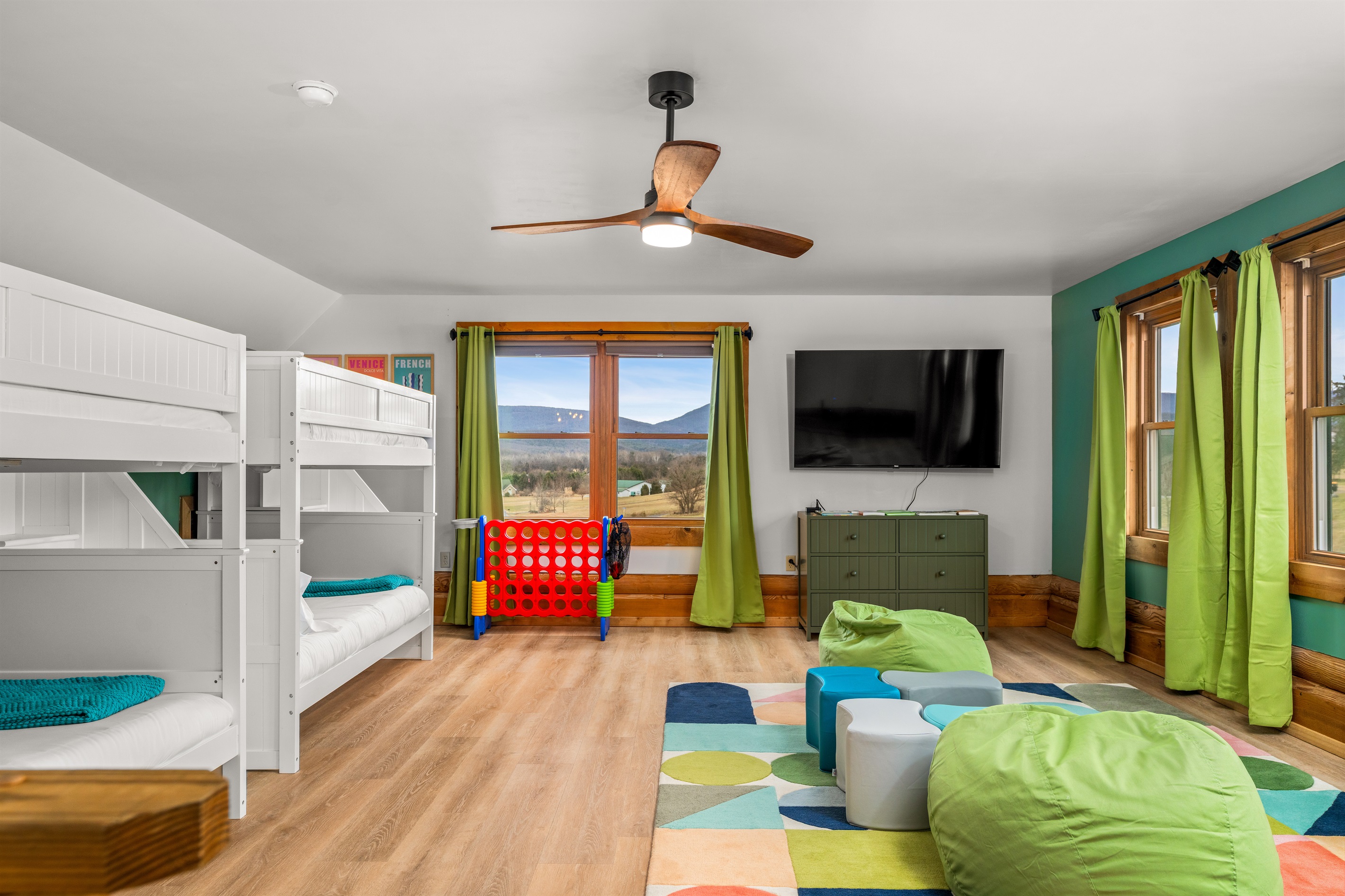 Spacious room with two full bunk beds, seating area, and a view.