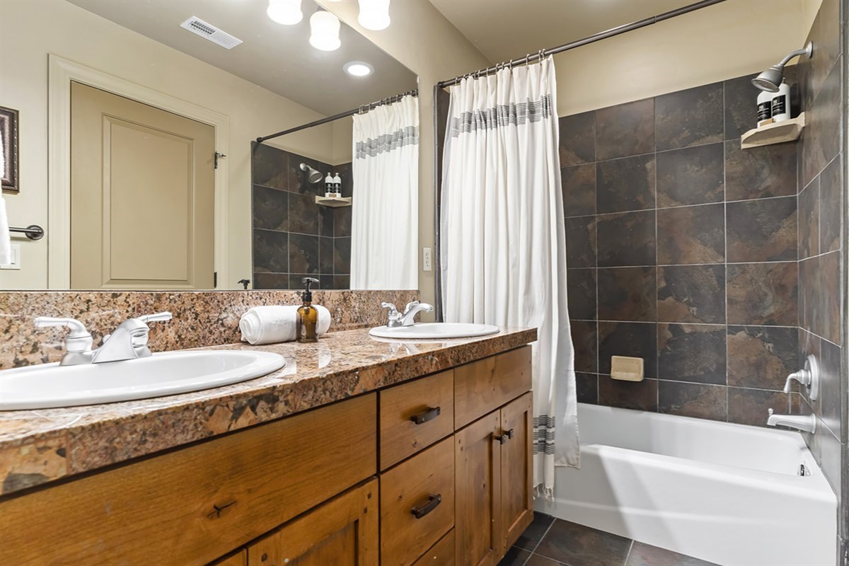 Full bathroom with tub/shower combo and clean, modern finishes.