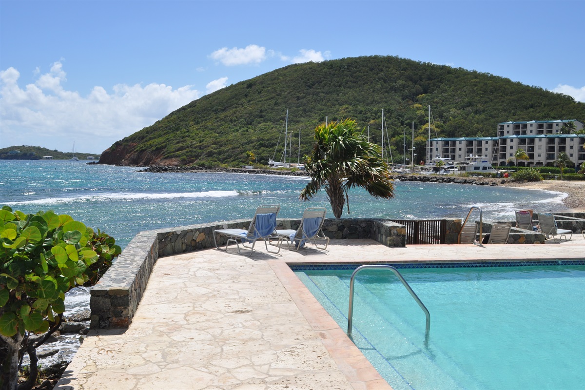 Beautiful pool area surrounded by tropical scenery&mdash;your perfect place to relax between beach trips.