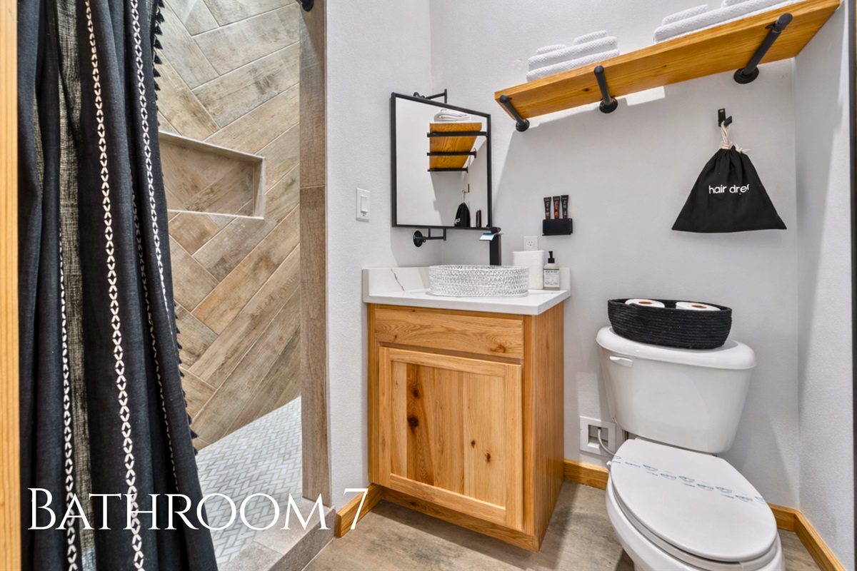 Bathroom 7 includes modern fixtures and a beautifully tiled shower, offering a clean and refreshing space.